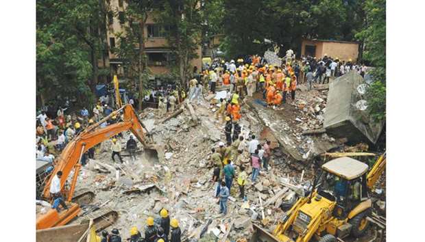 Rescue workers search for survivors among the debris at the site of the building collapse in Ghatkopar, Mumbai, yesterday.