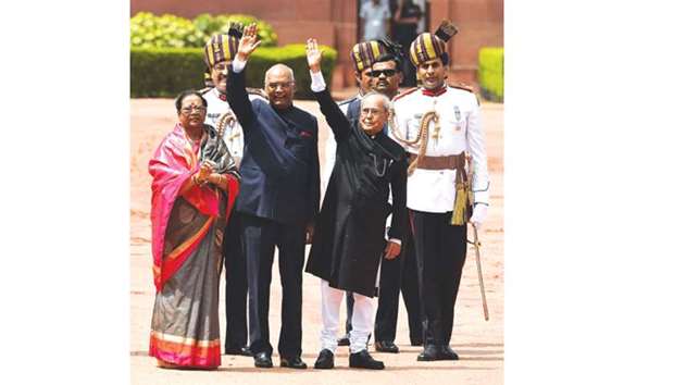 President Ram Nath Kovind and former president Pranab Mukherjee wave during a ceremony at the presidential palace in New Delhi yesterday.