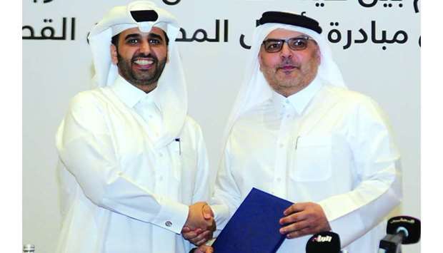 Ashghal president Dr Saad bin Ahmed bin Ibrahim al-Mohannadi and QDB CEO Abdulaziz bin Nasser al-Khalifa shake hands after signing the MoU. PICTURE: Nasar TK