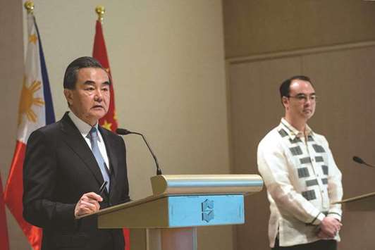 Chinau2019s Foreign Minister Wang Yi (left) and Philippine Foreign Affairs secretary Alan Peter Cayetano attend a joint press conference in Manila yesterday. China urged southeast Asian nations to unite and u201csay nou201d to outside forces seeking to interfere in the South China Sea dispute u2014 an apparent swipe at the US ahead of a regional summit.