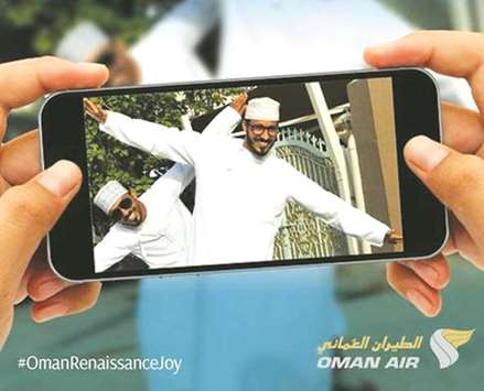 A man taking a photograph to enter the Oman Air contest.