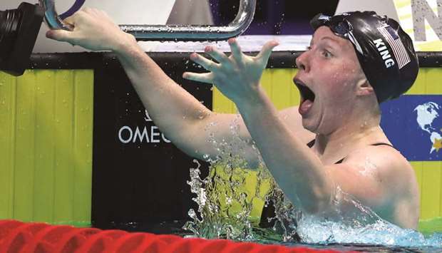 Lilly King of the US reacts after winning the womenu2019s 100m breaststroke and breaking the world record during the 17th FINA World Aquatics Championships.