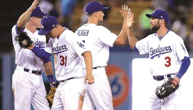 Los Angeles Dodgers left fielder Chris Taylor (right) and shortstop Corey Seager (second right) celebrate their 6-2 victory against the Minnesota Twins at Dodger Stadium. PICTURE: USA TODAY Sports