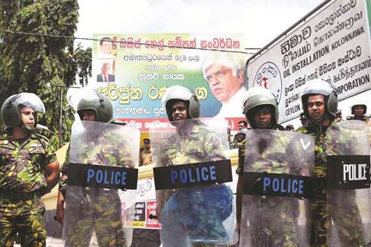 Special Task Force (STF) members stand guard in front of the Ceylon Petroleum Corporation during a strike by employees in Colombo yesterday.