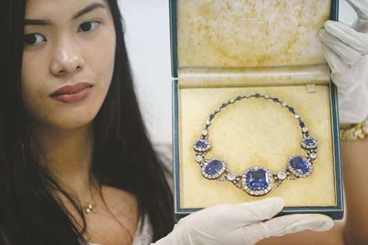 File photo shows an official from the Presidential Commission on Good Government (PCGG) showing a piece of jewellery seized by the Philippine government from former first lady Imelda Marcos, at the Central Bank headquarters in Manila.