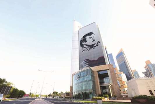 The u2018Tamim Al Majdu2019 mural on the fau00e7ade of the Commercial Bank Plaza building.