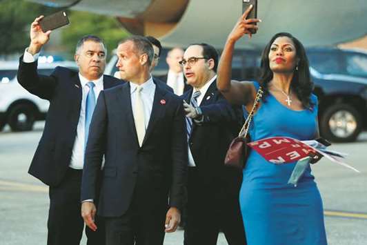 Former campaign aides David Bossie and Corey Lewandowski pose with White House Director of Advance George Gigico, as White House adviser Omarosa Manigault (R) takes one as well, as they board Air Force One to return with US President Donald Trump to Washington from Youngstown-Warren Regional Airport in Vienna, Ohio.
