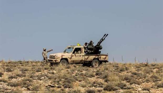 Hezbollah members manning an anti-aircraft gun mounted on a pick-up truck in a mountainous area around the Lebanese town of Arsal along the border with Syria.