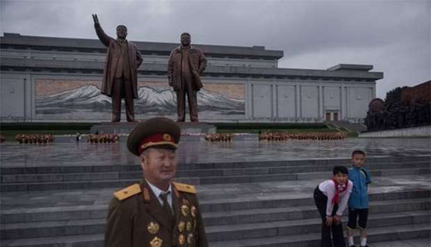 A retired Korean People's Army soldier walks away after bowing before the statues of late North Korean leaders Kim Il-Sung (left) and Kim Jong-Il as the country marks 'Victory Day' at Mansu hill in Pyongyang on Thursday.