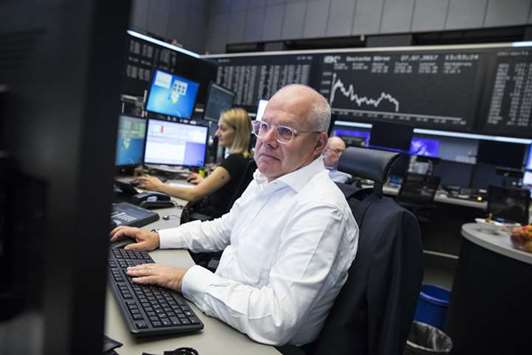 Traders monitor financial data inside the Frankfurt Stock Exchange yesterday. The DAX 30 closed the day 0.8% down at 12,212.04 points.