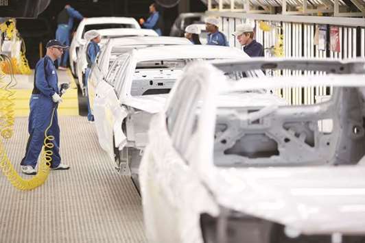 Employees inspect vehicle frames inside the paint shop at the Hyundai Motor Manufacturing Alabama (HMMA) facility in Montgomery, Alabama. The US Commerce Department said non-defence capital goods orders excluding aircraft, a closely watched proxy for business spending plans, slipped 0.1% last month. That was the first drop since December and followed a 0.7% jump in May, which was the biggest gain since January.