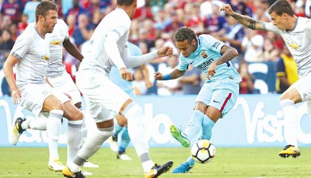 Barcelona's Neymar scores past Manchester United defenders during the International Champions Cup friendly match in Landover, Maryland. (AFP)