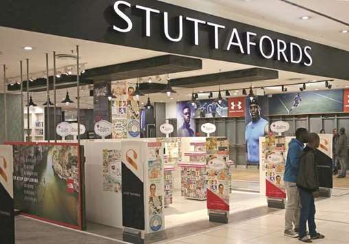 Shoppers walk past empty shelves at the Stuttafords department store in Sandton, Johannesburg.