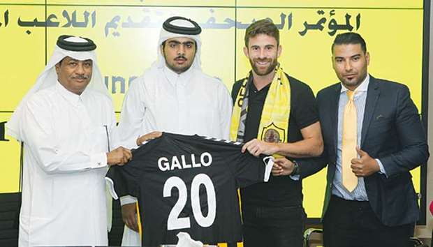 Brazilian midfielder Bruno Gallo (centre right) poses with his jersey and officials after signing up for Qatar SC in Doha yesterday.