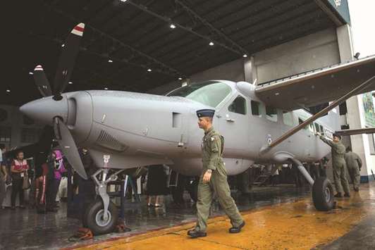 Philippine Air Force (PAF) pilots check on a Cessna-208B Grand Caravan Intelligence, Surveillance and Reconnaissance (ISR) aircraft acquired through grant programmes by the US government to the PAF during a formal turn-over ceremony at the PAF headquarters in Manila yesterday.