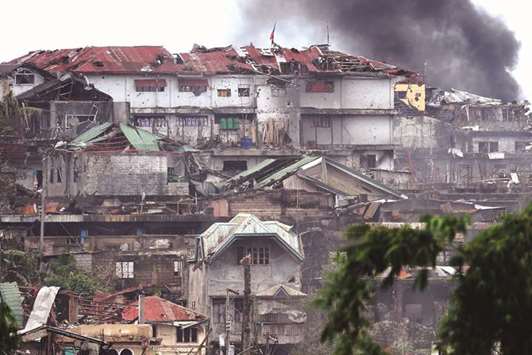 A recent photo shows black smoke billowing from a burning house after an aerial strike by Philippine Air Force attack helicopters targeting militants in Marawi.