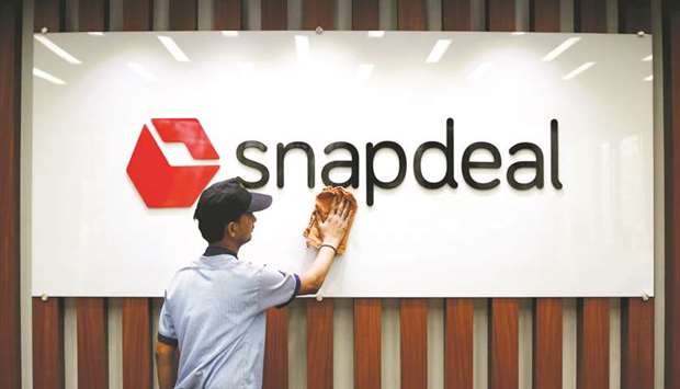 An employee cleans a Snapdeal logo at its headquarters in New Delhi. The board of Jasper Infotech, which runs Snapdeal, approved Flipkartu2019s bid of $900mn-$950mn last week, sources said.
