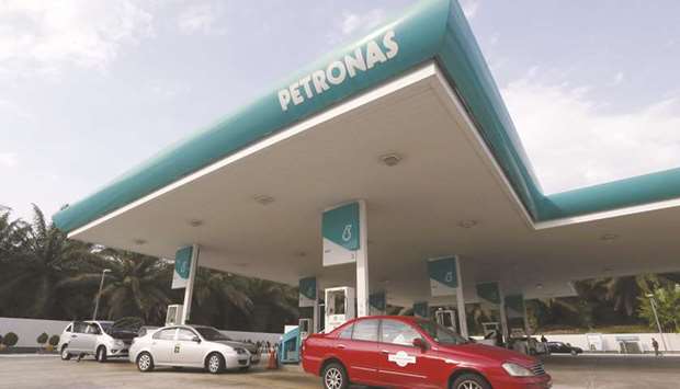 Taxis refuel at a Petronas petrol station outside Kuala Lumpur. Petronas had planned to produce its own gas to supply Pacific NorthWest LNG, rather than buying it from other producers, but no LNG demand means firms like Painted Pony Petroleum and Seven Generations Energy will continue to see low gas prices, analysts said.