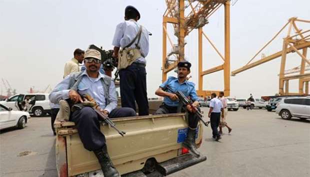 Police troopers ride on the back of a patrol truck during a visit by a UN delegation to the Red Sea port of Hodeidah, Yemen this week.