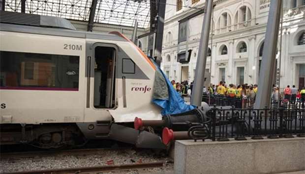 A tarp covers the damaged front end of a train at Francia station in Barcelona on Friday.