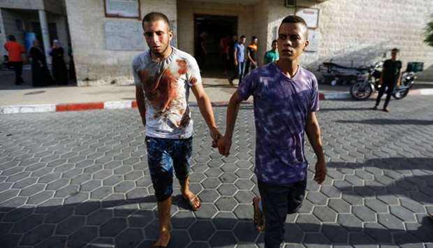 Relatives of a 16-year-old Palestinian, who was reportedly killed in clashes with the Israeli army along the Gaza border, leave the hospital where his body lies in Deir al-Balah in the central Gaza strip.