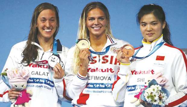 Yuliya Efimova of Russia (gold), Bethany Galat of the US (silver) and Jinglin Shi of China (bronze) pose with their medals after the 200m breaststroke event yesterday.