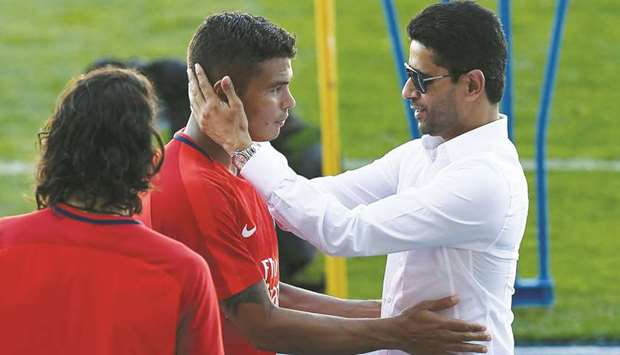 Paris Saint-Germainu2019s Qatari president Nasser al-Khelaifi (R) speaks with the teamu2019s Brazilian defender Thiago Silva (C) at the end of a training session at the Grand Stade in Tangiers yesterday.