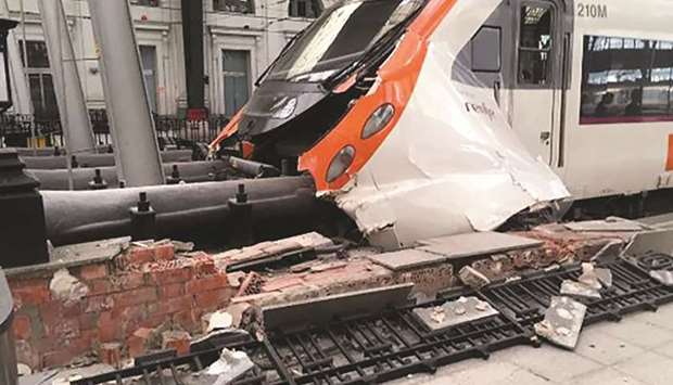 A picture taken and obtained from the Instagram account u201cUngatodecheshireu201d shows a commuter train which slammed into the end of the platform during the morning rush hour at Francia station in the Spanish city of Barcelona yesterday.