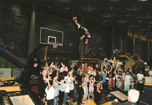 A member of the Dunking Devil takes off above a crowd towards the ring.