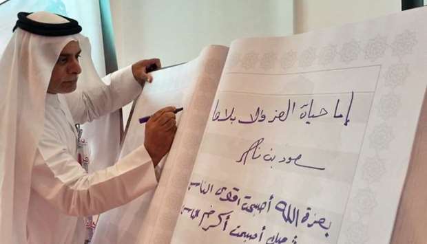 Ooredoo Qatar COO Yousuf Abdulla al-Kubaisi signs the book