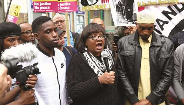 Britainu2019s Shadow Home Secretary, Diane Abbott speaks at a protest outside Stoke Newington police station over the death of Rashan Charles.