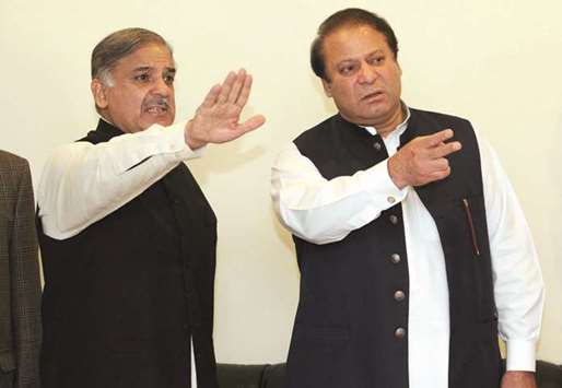 This file photo taken on February 25, 2009 shows former Pakistani prime minister Nawaz Sharif arriving with his brother Shahbaz Sharif for a press conference in Lahore.