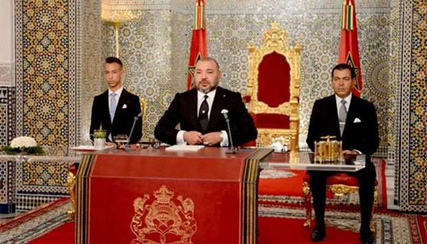 King Mohammed VI (centre) delivering a speech to mark the 16th anniversary of his accession to the throne, beside his brother Prince Moulay Rachid (right) and son Hassan III (left) in Tetouan.