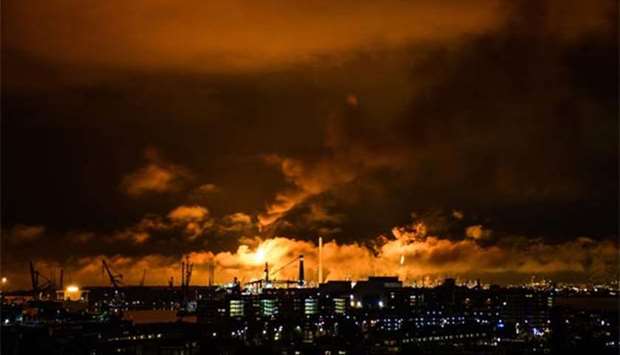 Flames and smoke rising above the Shell refinery in Rotterdam.