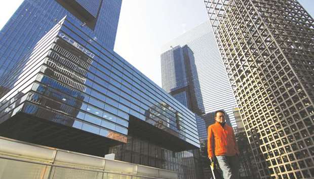 A pedestrian walks in front of the Samsung Electronics headquarters in Seoul. The worldu2019s top smartphone maker will be confronted by tougher challenges in the future as Chinese rivals take aim at its semiconductor business and questions emerge over the firmu2019s leadership.