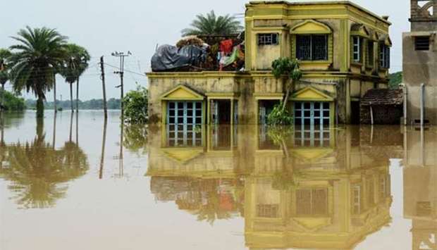 A submerged home is surrounded by flood waters in the Amta area of Howrah district, around 55km west of Kolkata, on Sunday.
