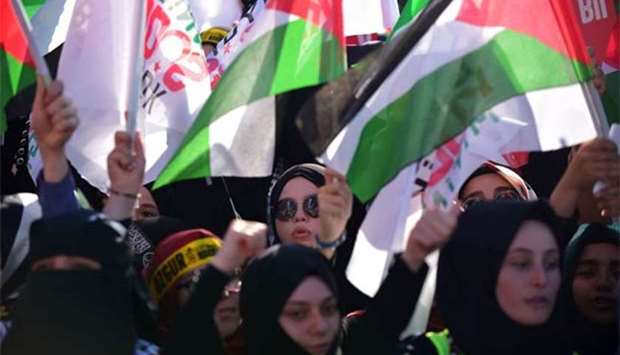 Protesters wave Turkish and Palestinian flags during a demonstration in Istanbul on Sunday.