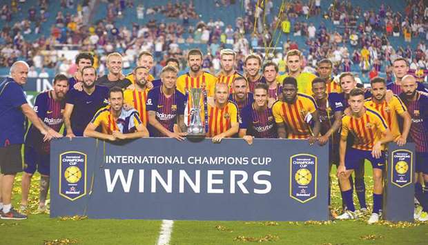 Barcelona team pose with the  trophy after beating Real Madrid in the International Champions Cup match at Hard Rock Stadium in Miami, Florida, on Saturday. (AFP)