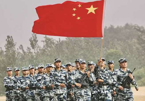 Chinese troops march with the national flag during the International Army Games 2017 at Guangshui, Hubei province.
