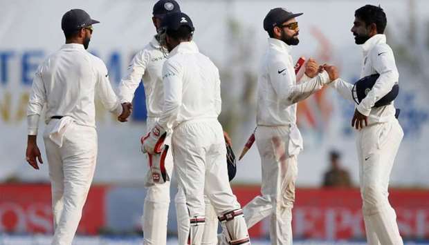 India's captain Virat Kohli and Abhinav Mukund celebrate with their teammates after winning the matc