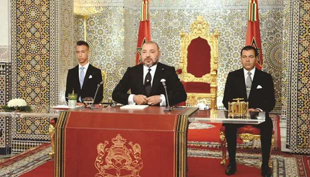 Moroccou2019s King Mohamed VI (centre) delivers a speech to mark the 16th anniversary of his accession to the throne, as his brother Prince Moulay Rachid (right) and son Hassan III (left) look on.