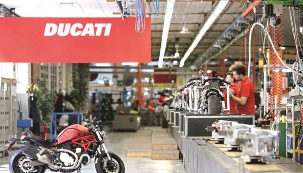 Employees work on Ducati 1299 Panigale motorcycles, produced by Ducati Motor Holding, a unit of Volkswagen, at the companyu2019s factory in Bologna, Italy. VW has tasked banks to evaluate options for Ducati and transmissions maker Renk including divesting the two divisions as it aims to streamline operations to help fund a  post-dieselgate strategic overhaul.