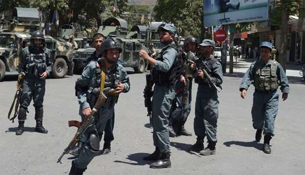 Afghan policemen arrive at the site of a suicide blast near Iraq's embassy in Kabul