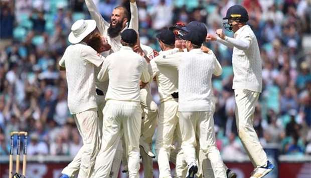 England's Moeen Ali (left) celebrates the victory with teammates at The Oval on Monday.