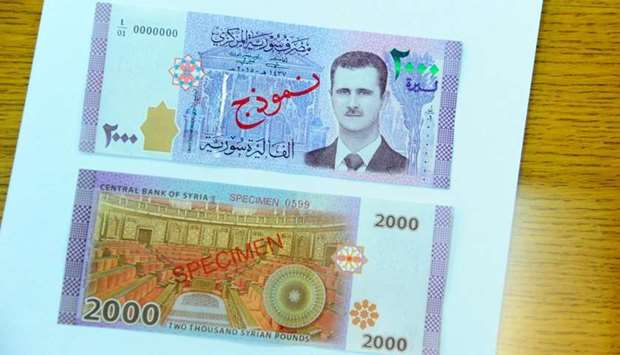 A portrait of Syria's President Bashar al-Assad is seen printed on the new Syrian 2,000-pound banknote