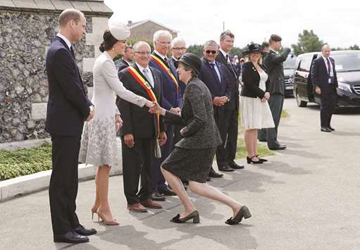 Britainu2019s Prime Minister Theresa May greets Prince William and Catherine the Duchess of Cambridge as she arrives at Tyne Cot cemetery for commemorations for the 100th anniversary of the battle of Passchendaele near Ypres in Belgium, yesterday.