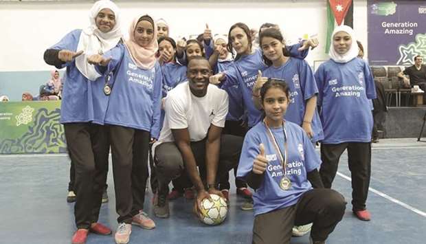 Bismack Biyombo pictured with girls during his visit to the Al Baqaa refugee camp in Jordan.