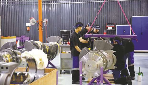 Employees work at an engine factory of CSSC Wartsila Engine in Shanghai. Growth in Chinau2019s manufacturing sector cooled slightly in July as foreign demand for Chinese goods slackened.