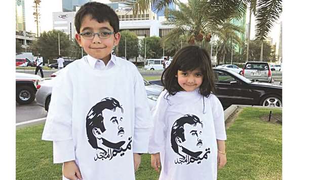 Children wear T-shirts with His Highness the Emiru2019s portrait.