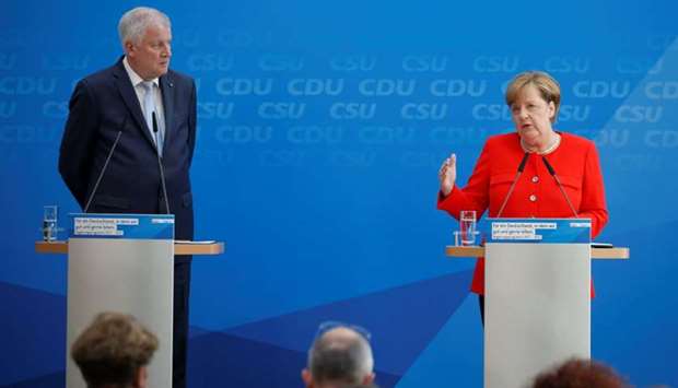 German Chancellor and head of the Christian Democratic Union (CDU) Angela Merkel (R) and head of Christian Social Union (CSU) Horst Seehofer attend a news conference after meeting of their conservative bloc to discuss their election programme in Berlin